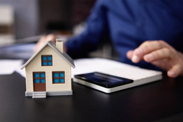 The Ultimate Guide to Filing a Successful Home Insurance Claim - Person Hand Doing Property Tax Calculation Using Calculator