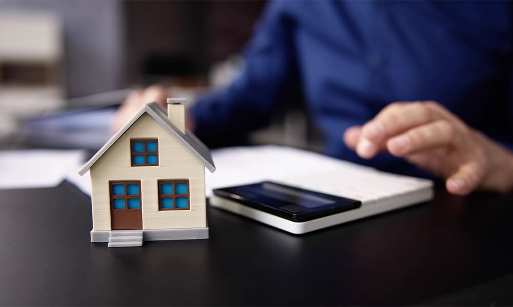 The Ultimate Guide to Filing a Successful Home Insurance Claim - Person Hand Doing Property Tax Calculation Using Calculator